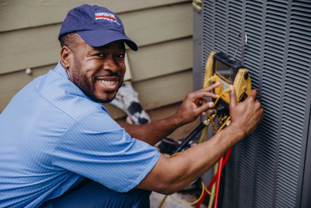 hvac technician completing an AC inspections on an HVAC unit