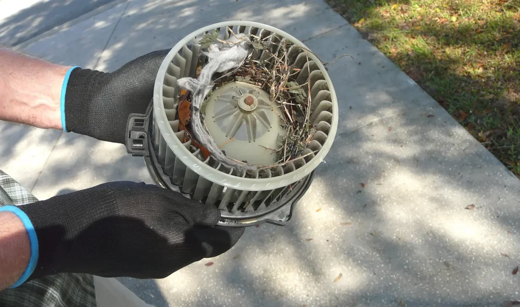 TemperaturePro Mokena technician holding dirty furnace blower motor.