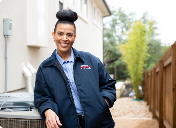 ProPlan-Imge-2 Woman leans against an outdoor HVAC unit.